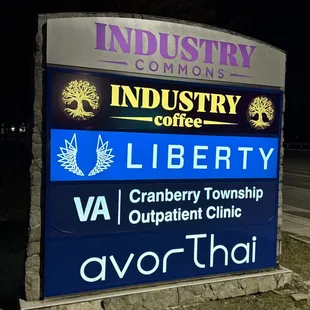 Industry Commons plaza sign with Industry Coffee, Instant Imprints, Avor Thai, Liberty Dispensary, and the Cranberry VA Outpatient Clinic