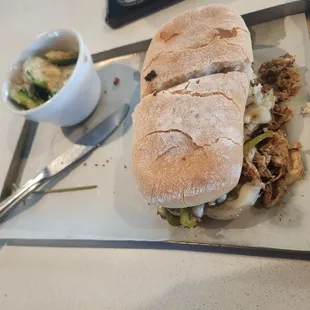 Chicken avocado sandwich with brussel sprouts.