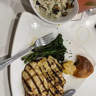 a plate of grilled chicken, asparagus, and a side of rice