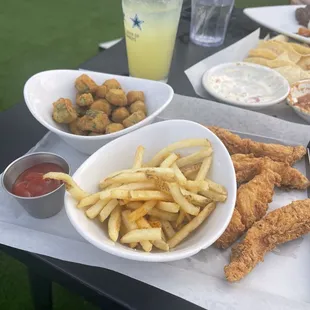 Chicken fingers, fries, fried okra, chips, salsa, queso, and a margarita
