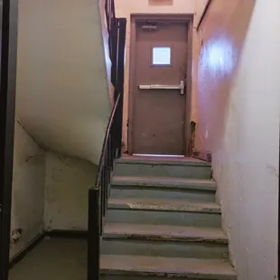 Stairs leading up to the back entrance from the basement of the Marleigh.