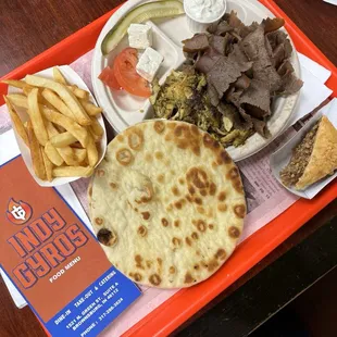 Dinner plate with lamb and chicken. And a piece of baklava