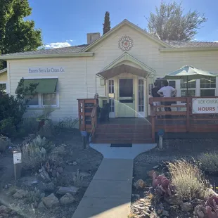 Cute, welcoming storefront with outdoor seating.
