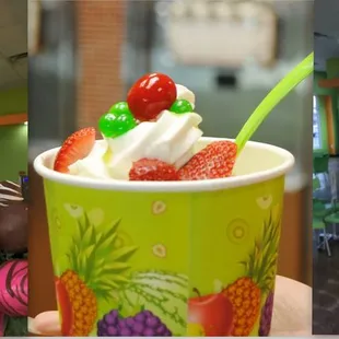 a hand holding a cup of ice cream