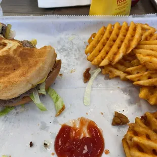 Half eaten original burger  Waffle fries