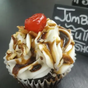 a cupcake topped with whipped cream and caramel