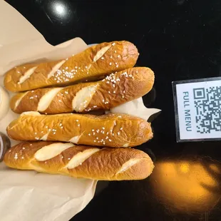 a plate of breadsticks and dipping sauce