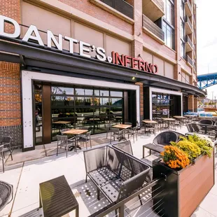 the outside of a restaurant with tables and chairs