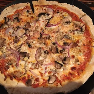 Truffle pizza: fresh mozzarella, cremini mushroom, onions, garlic, white truffle oil