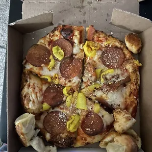 Personal pizza with peaceful rebel, vegan pepperoni and banana pepper.