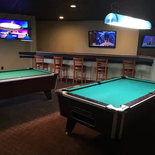 two pool tables and a television