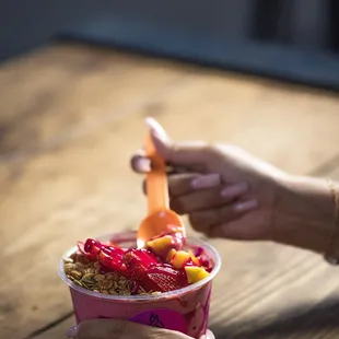 a person eating a bowl of food