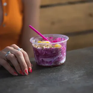 a woman sitting at a table with a bowl of food