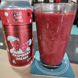 a glass of raspberry dream next to a can of raspberry dream