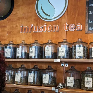 a woman looking at a display of tea