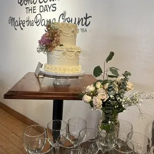 a cake and wine glasses on a table