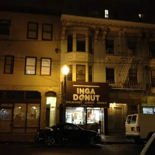 the outside of a donut shop at night