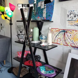 Supporting local artists by selling their jewelry and trinkets.