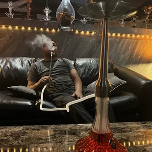 a man smoking a hookah