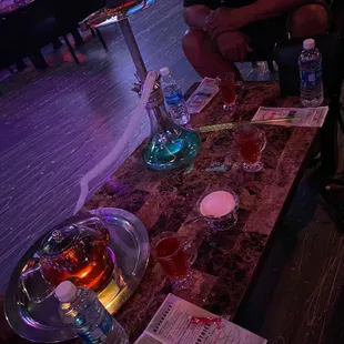 a man sitting at a table with a hookah