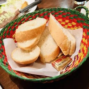 a basket of bread and a plate of food