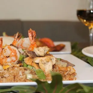 a plate of food and a glass of wine