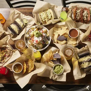 a table full of tacos and chips