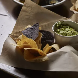 a bowl of guacamole and chips