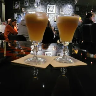 two glasses of beer on a table