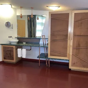 Sink, counter, wardrobe and mini refrigerator area in guest room.  No coffee maker provided!
