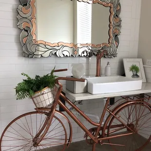 a bicycle leaning against a mirror