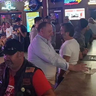 a group of people sitting at a bar