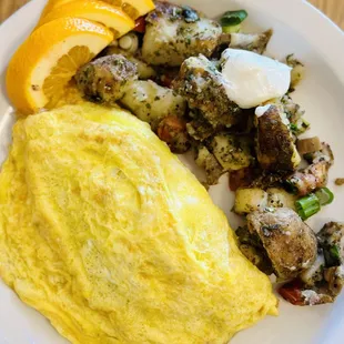 an omelet, potatoes, and a slice of orange