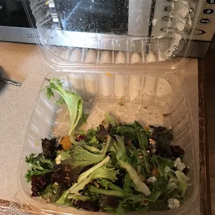a salad in a plastic container