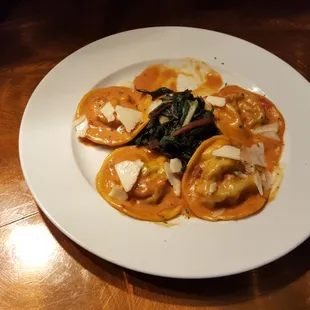 Braised Beef Ravioli with sautéed swiss chard, sherry herb sauce and pecorino