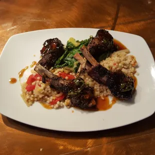 Lamb Chops topped with a mint demi-glace and served with braised fennel and roasted red pepper couscous and sautéed Swiss chard.