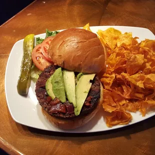 Handmade Black Bean burger with avocado, tomato jam served on a brioche bun
