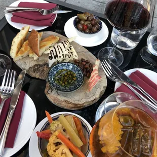 Wine, olives, and cheese board during happy hour