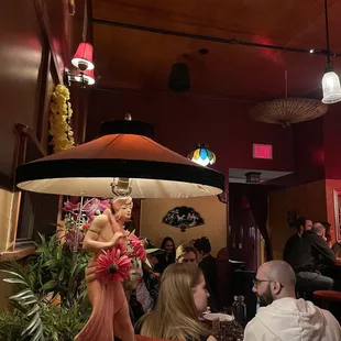 a statue of a woman holding an umbrella in a restaurant
