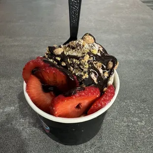 Cookies and cream ice cream with Reese's Puff, fresh strawberries and chocolate drizzle