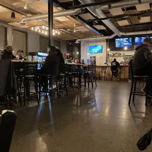 people sitting at tables in a bar