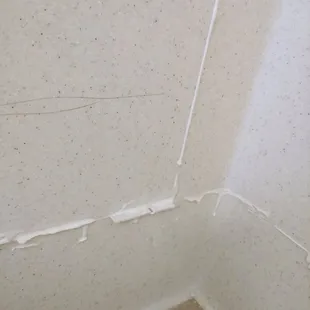 Wall panels are set with color matching epoxy, then sanded to a smooth, seamless finish.  No caulk is used.