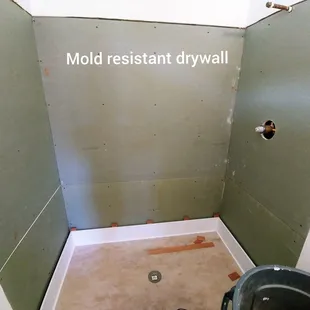 Mold resistant drywall hung before Corian walls are installed.