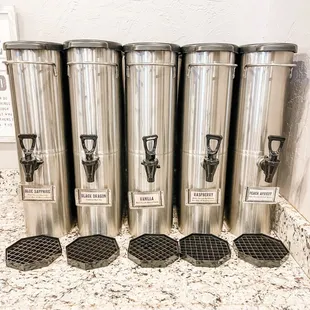 a row of coffee urns