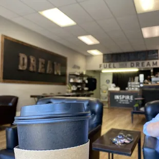 a person holding a cup of coffee