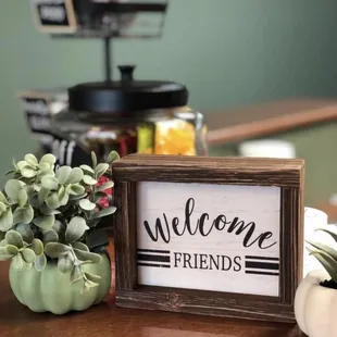 a welcome sign with succulent succulents