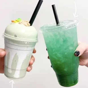 a hand holding a cup of lucky leprechaun iced tea and a cup of lucky charms shake