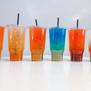 a row of different colored drinks