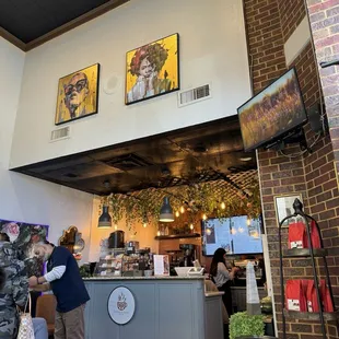 a man and a woman standing in a coffee shop