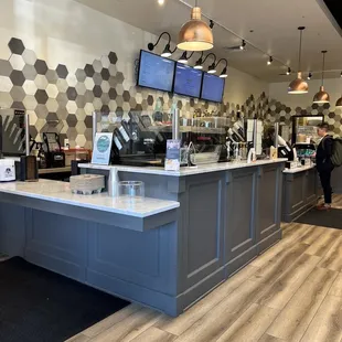a coffee shop with a counter and tvs
